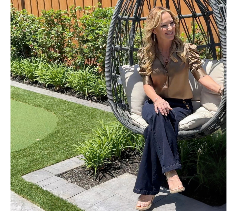 Allison Gaddy seated in a garden hanging chair