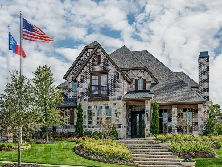Real exterior of the Newport Homebuilders Lantana Bellaire model home, historic builder gallery