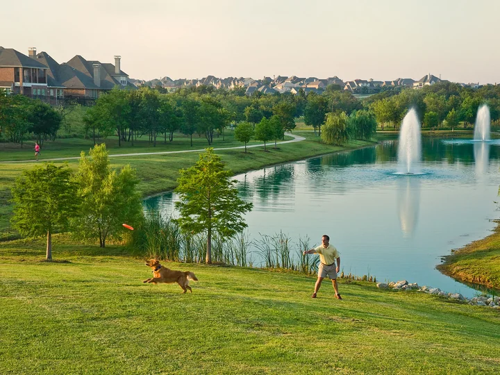 Castle Hills lake, fountains, paths, and adjacent residential landscape