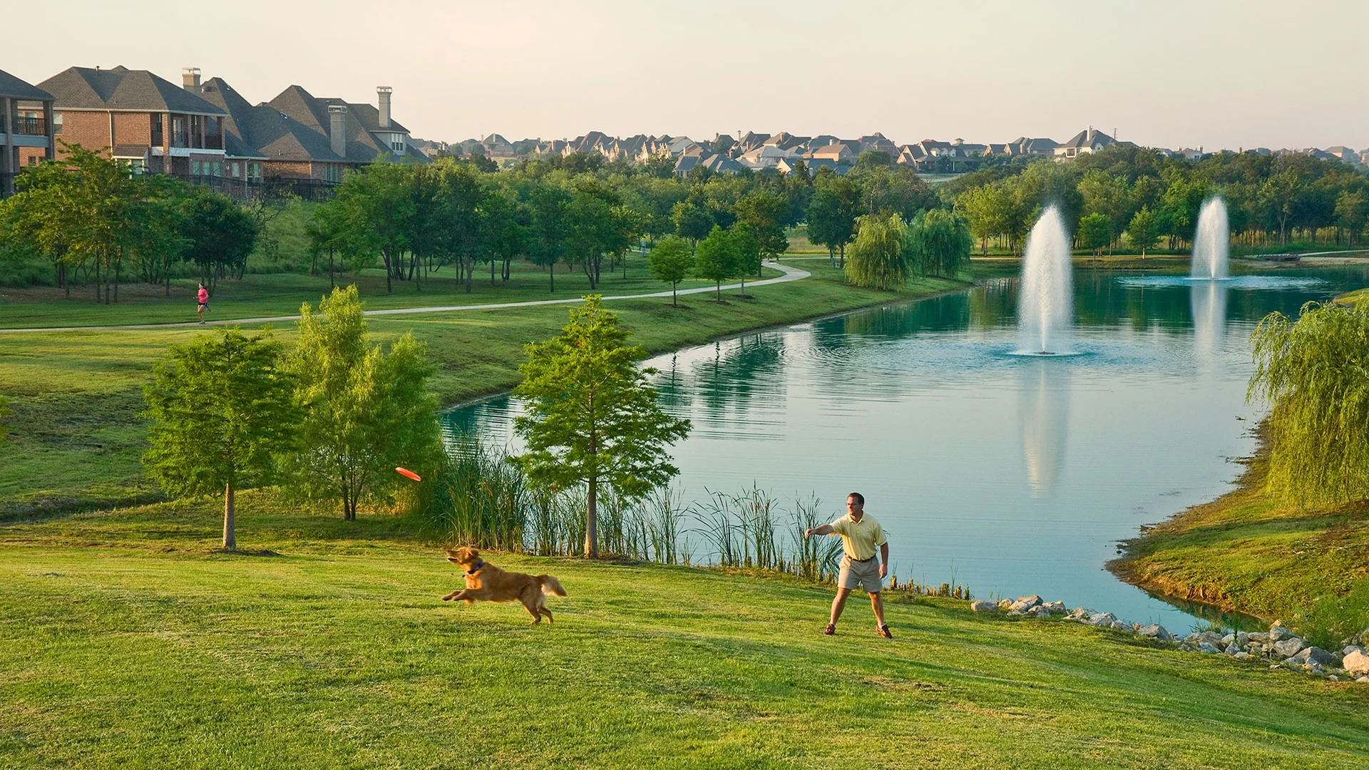Castle Hills lake, fountains, paths, and adjacent residential landscape