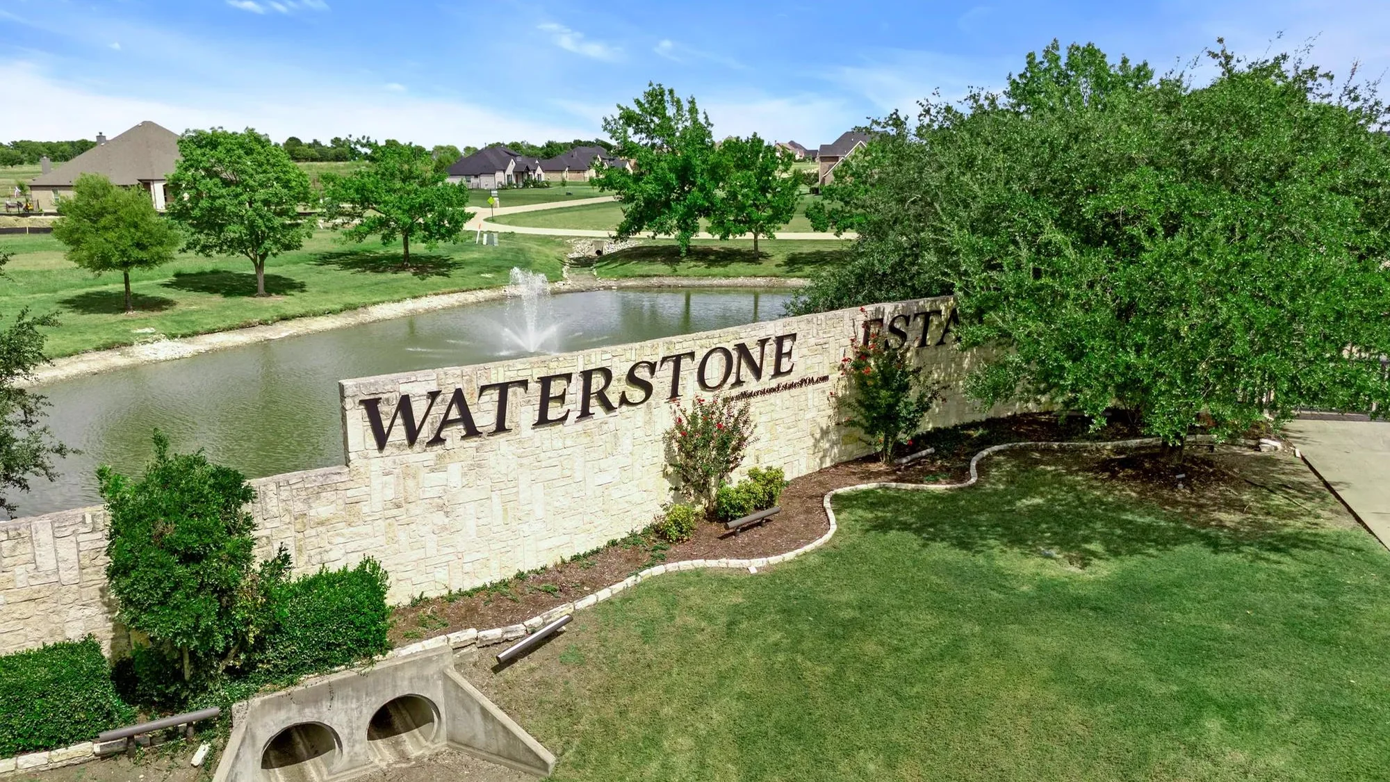Drees Custom Homes aerial photograph of the named Waterstone Estates entry sign and pond