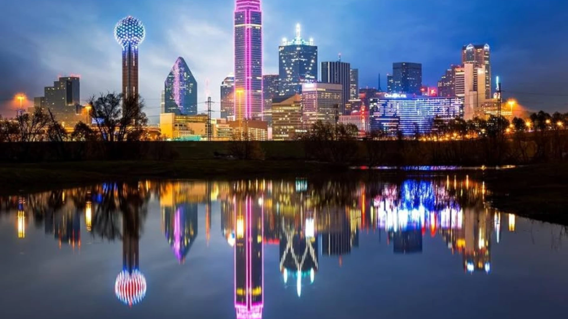 Downtown Dallas skyline at night reflected in still water