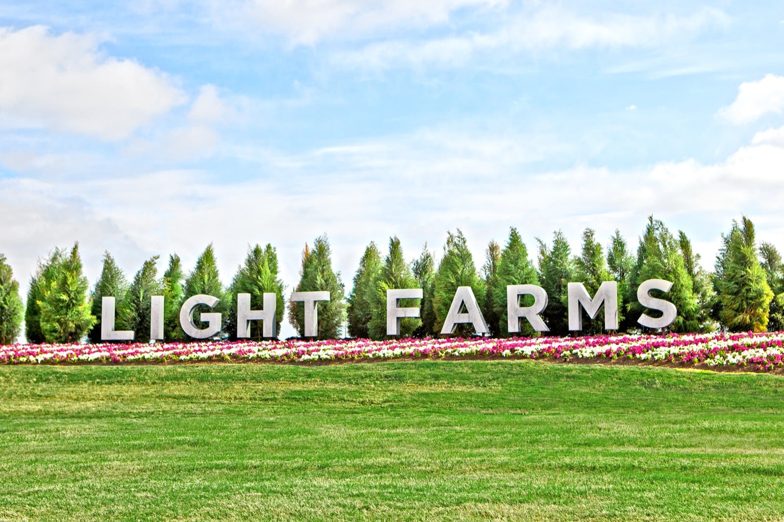 Landscaped Light Farms community entrance sign in Celina, Texas